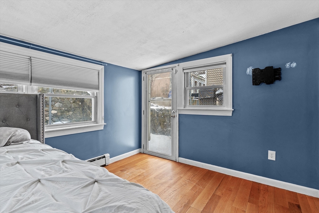 116 Weare Street Lawrence, MA 01843 - Photo 11 of 25 a bedroom with a bed and a window