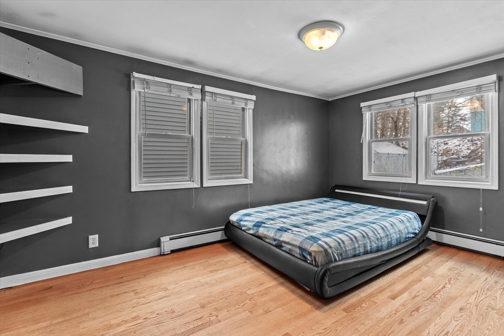 116 Weare Street Lawrence, MA 01843 - Photo 12 of 25 a bedroom with a bed and a window