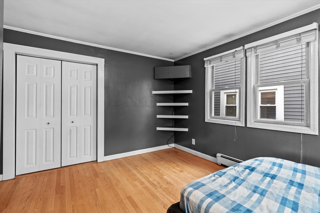 116 Weare Street Lawrence, MA 01843 - Photo 13 of 25 a bedroom with a bed and a window
