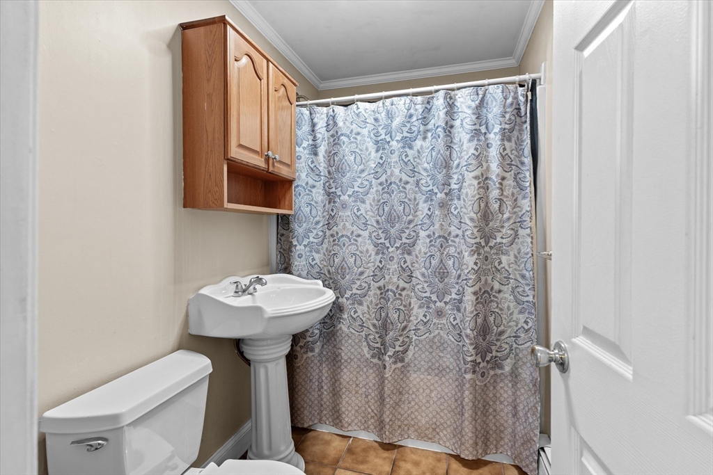 116 Weare Street Lawrence, MA 01843 - Photo 16 of 25 a bathroom with a sink toilet and a mirror