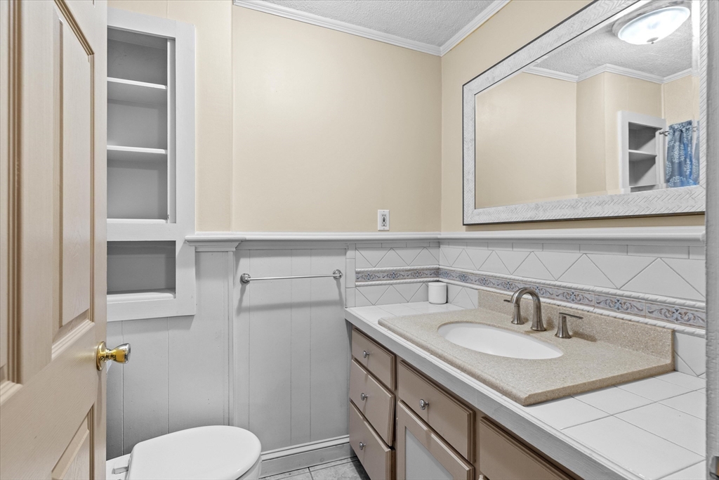 116 Weare Street Lawrence, MA 01843 - Photo 17 of 25 a bathroom with a sink toilet and mirror