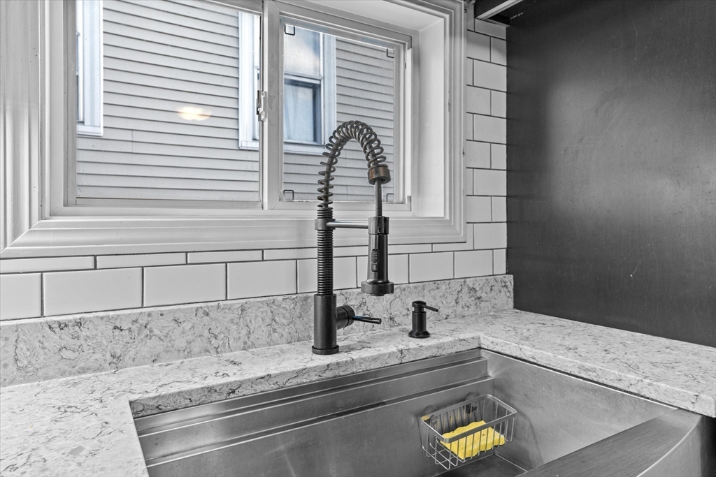 116 Weare Street Lawrence, MA 01843 - Photo 4 of 25 a bathroom with a bathtub and a window