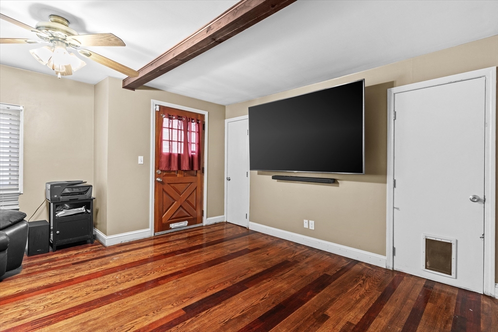 116 Weare Street Lawrence, MA 01843 - Photo 8 of 25 a bedroom with a bed and a flat screen tv