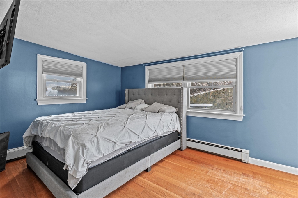 116 Weare Street Lawrence, MA 01843 - Photo 10 of 25 a bed sitting in a bedroom next to a window