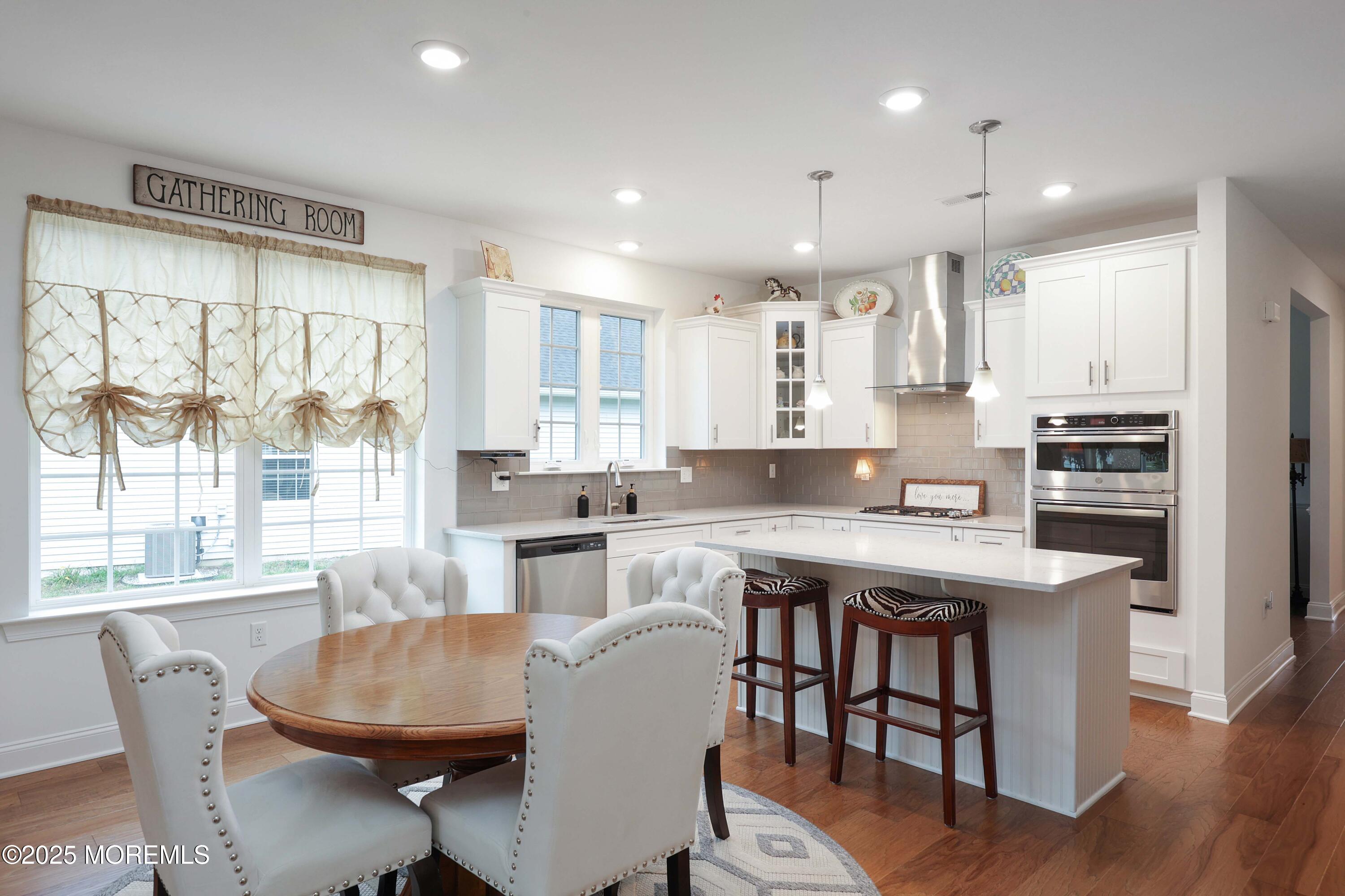 152 Edenton Drive Barnegat, NJ 08005 - Photo 7 of 36 a kitchen with stainless steel appliances granite countertop a table chairs stove refrigerator and cabinets