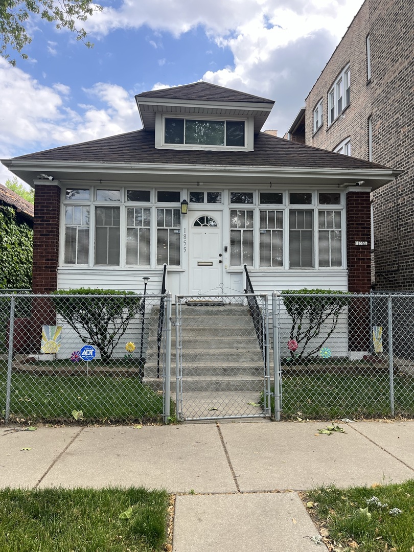1855 East 81st Street Chicago, IL 60617 - Photo 1 of 3 front view of a house with a yard