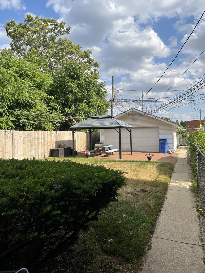 1855 East 81st Street Chicago, IL 60617 - Photo 2 of 3 a front view of a house with garden