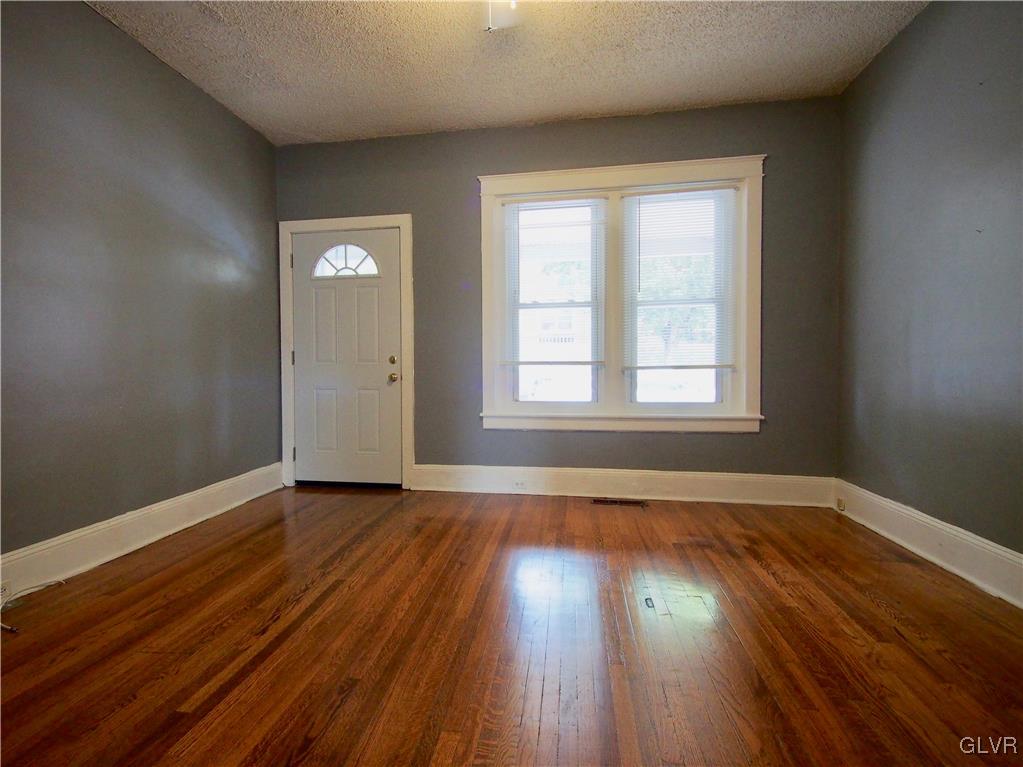 1021 Spring Street Bethlehem, PA 18018 - Photo 4 of 14 an empty room with wooden floor and windows