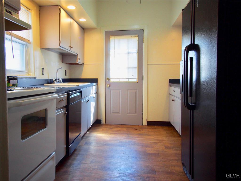 1021 Spring Street Bethlehem, PA 18018 - Photo 6 of 14 a kitchen with stainless steel appliances granite countertop a stove a refrigerator and a sink