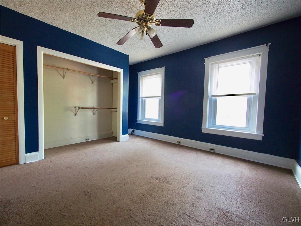 1021 Spring Street Bethlehem, PA 18018 - Photo 8 of 14 en empty room with windows and ceiling fan