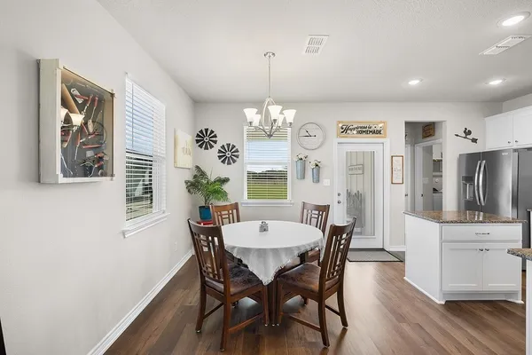 a view of a dining room with furniture window and wooden floor