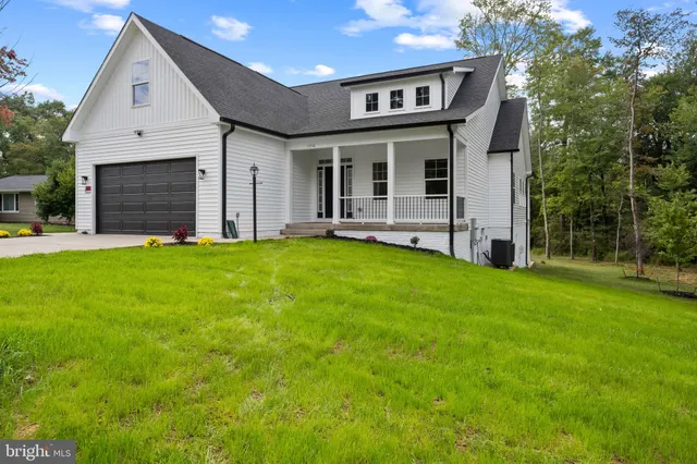 a view of a house with a yard and sitting area