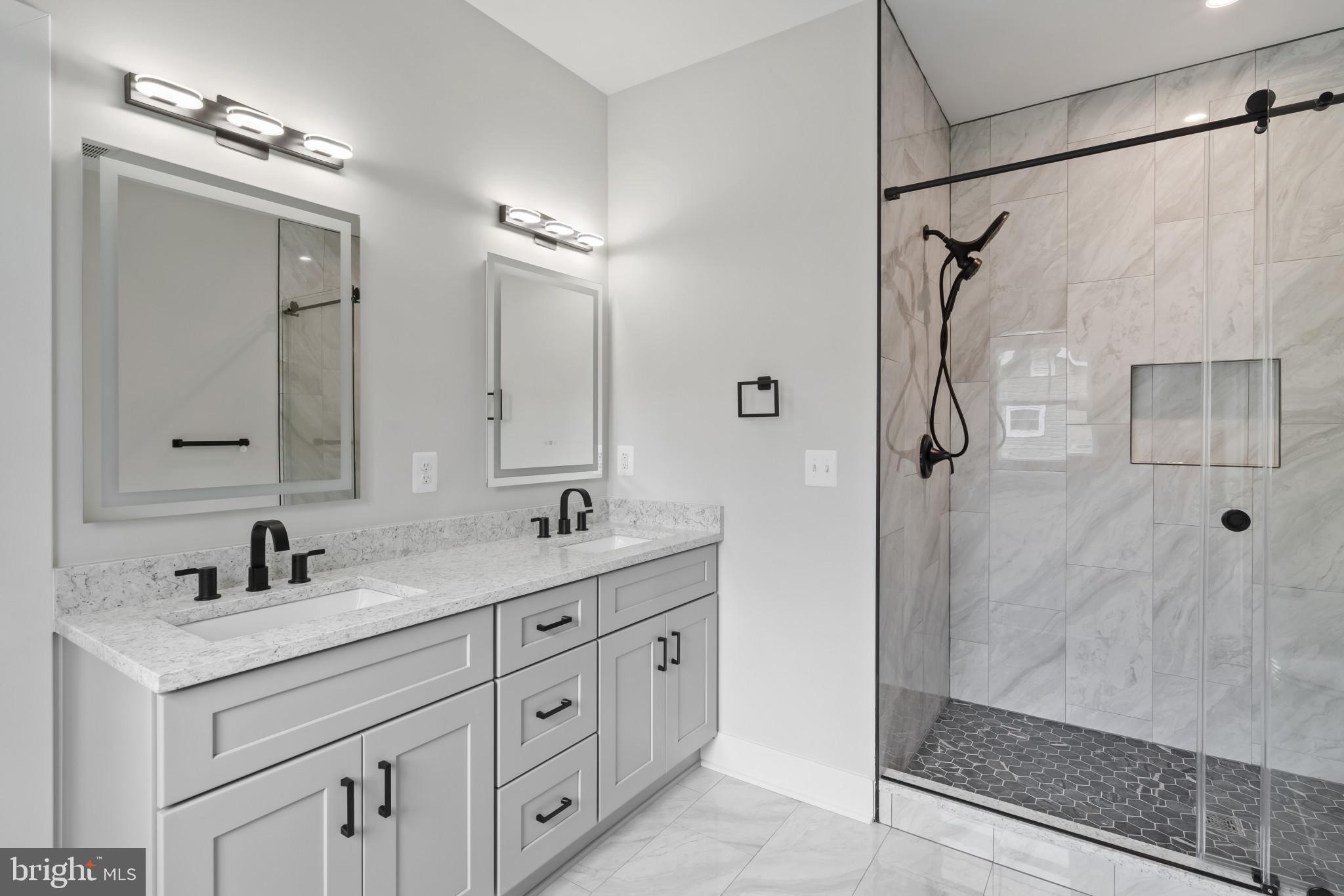 11516 Smithfield Road Manassas, VA 20112 - Photo 13 of 38 a bathroom with a double vanity sink mirror double and shower