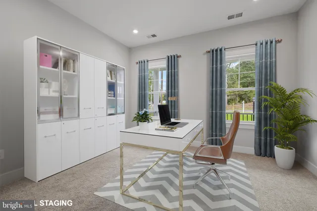 a living room with furniture a window and a potted plant
