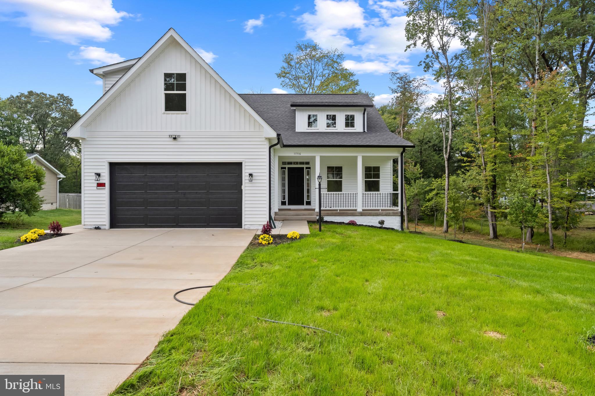 11516 Smithfield Road Manassas, VA 20112 - Photo 2 of 38 a front view of a house with a garden and yard
