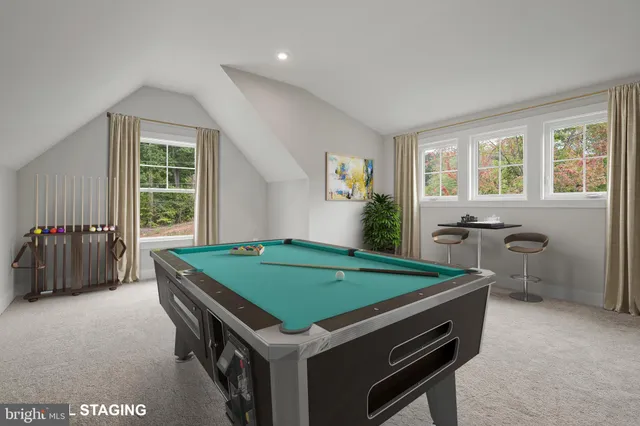 a room with pool table and windows