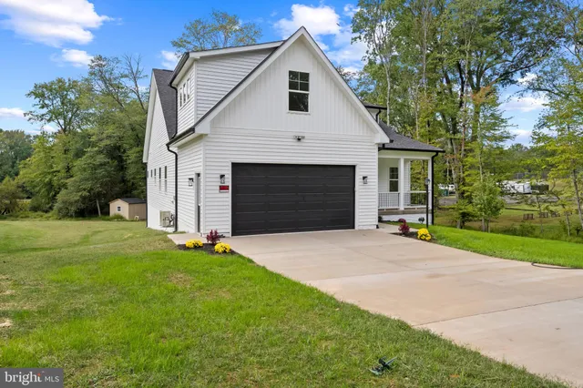 a front view of a house with yard and garage