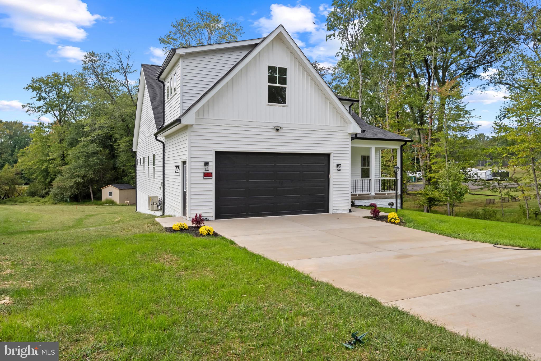 11516 Smithfield Road Manassas, VA 20112 - Photo 3 of 38 a front view of a house with yard and garage