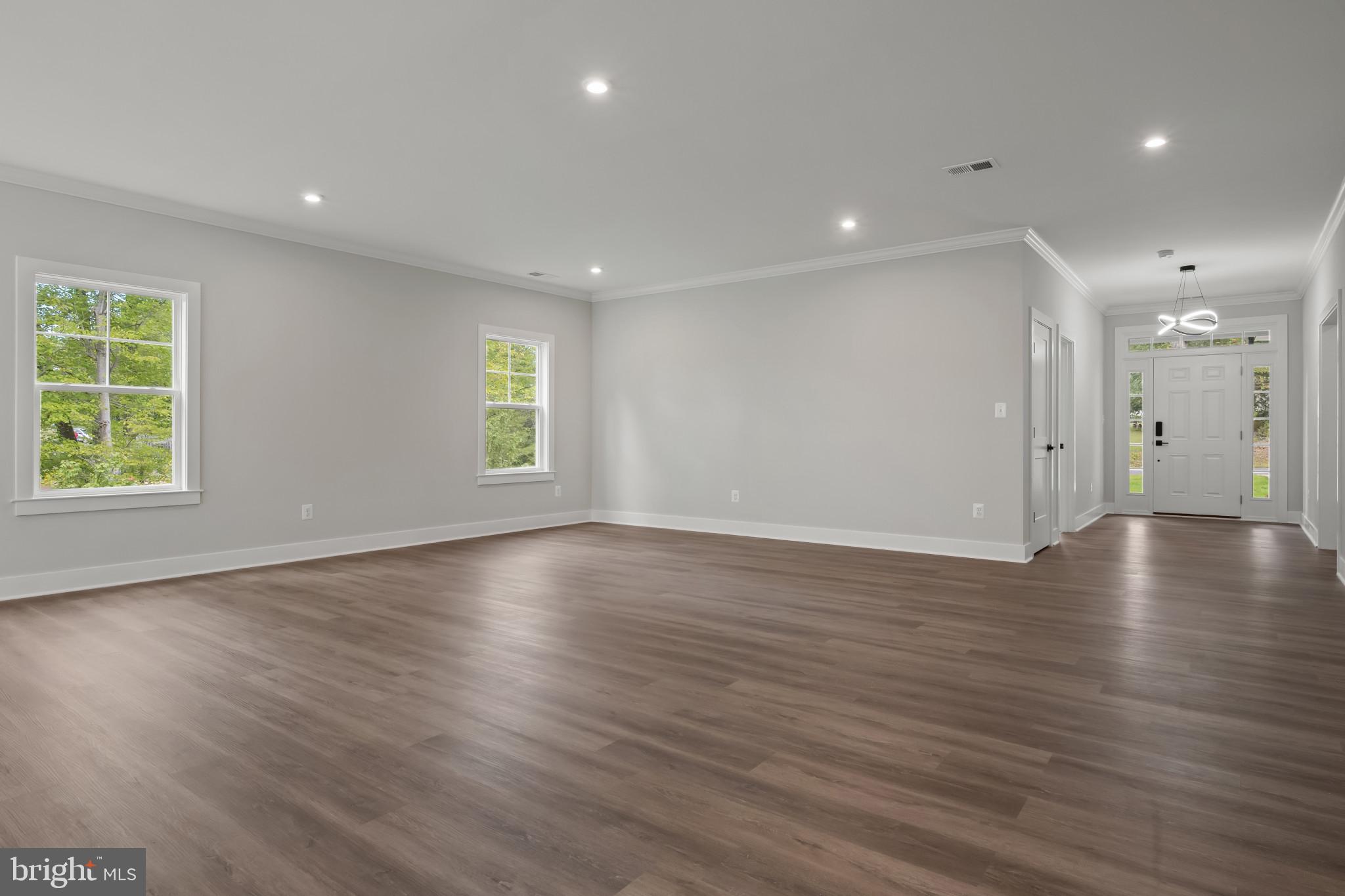 11516 Smithfield Road Manassas, VA 20112 - Photo 6 of 38 an empty room with wooden floor and windows