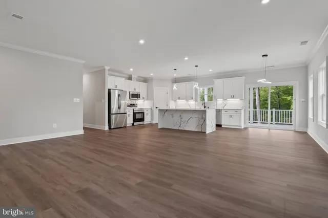 a view of kitchen with refrigerator and window