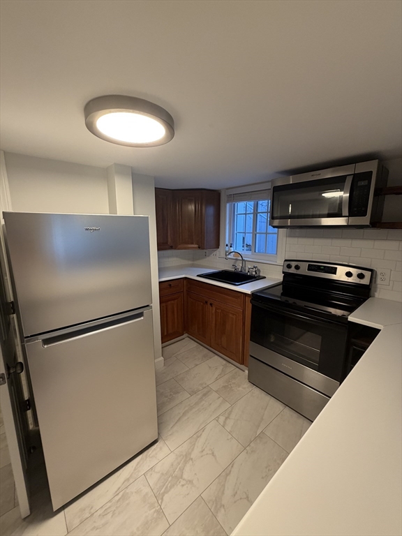 11 King Street, Unit 2 Swampscott, MA 01907 - Photo 2 of 8 a kitchen with a refrigerator and a stove