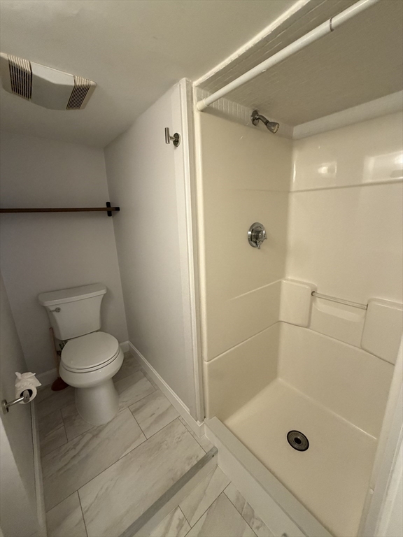 11 King Street, Unit 2 Swampscott, MA 01907 - Photo 7 of 8 a bathroom with a granite countertop shower a toilet and a shower