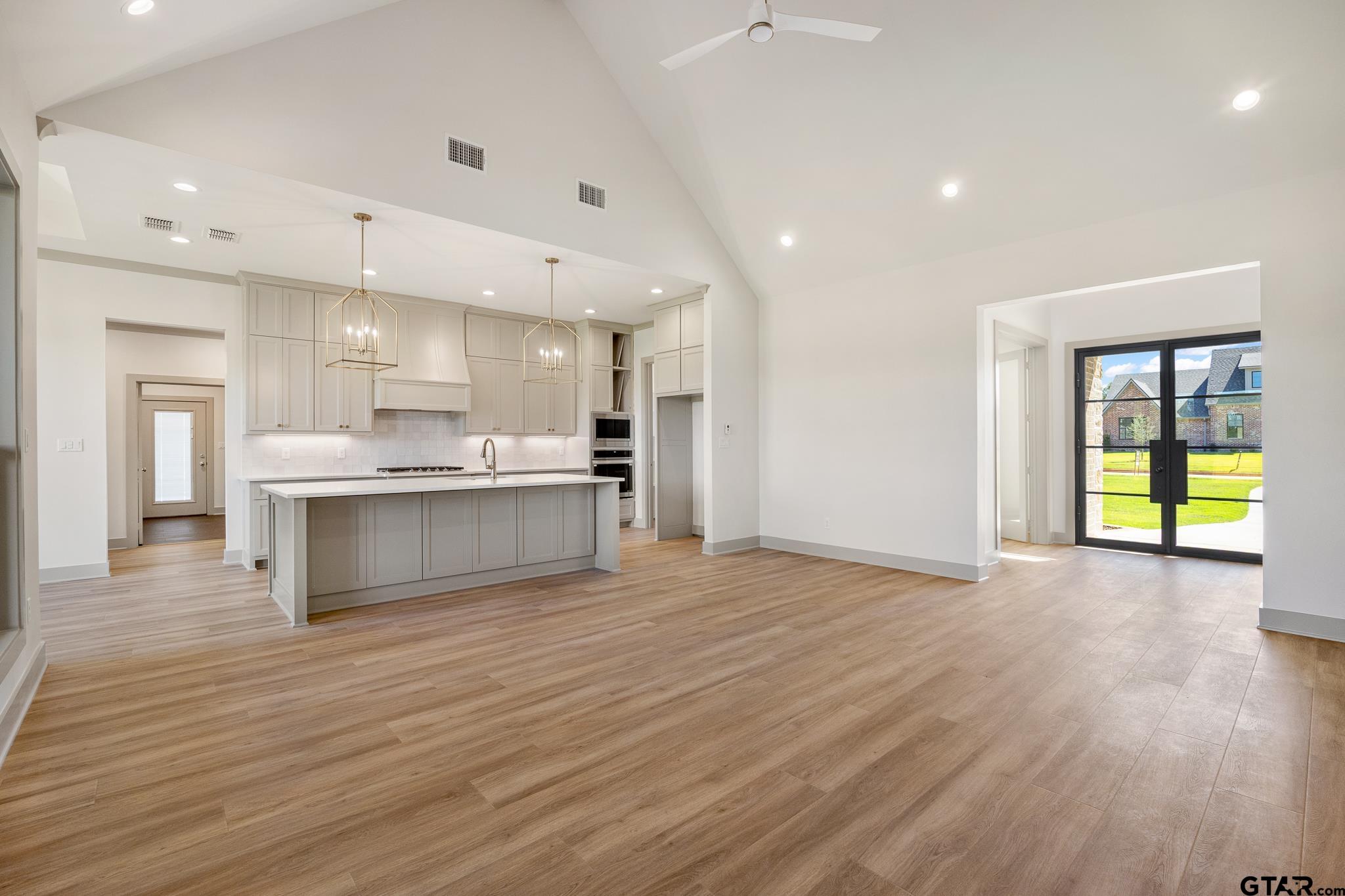 508 Artesian Meadow Drive Bullard, TX 75757 - Photo 11 of 46 a view of kitchen with kitchen island wooden floors appliances and cabinets