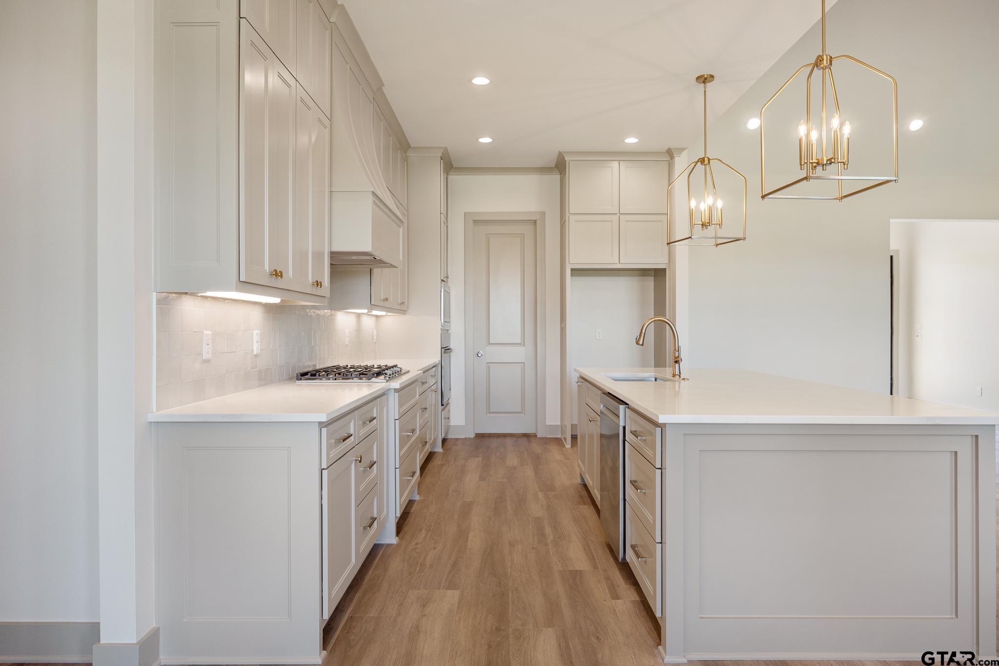 508 Artesian Meadow Drive Bullard, TX 75757 - Photo 15 of 46 a kitchen with kitchen island a sink stove and refrigerator