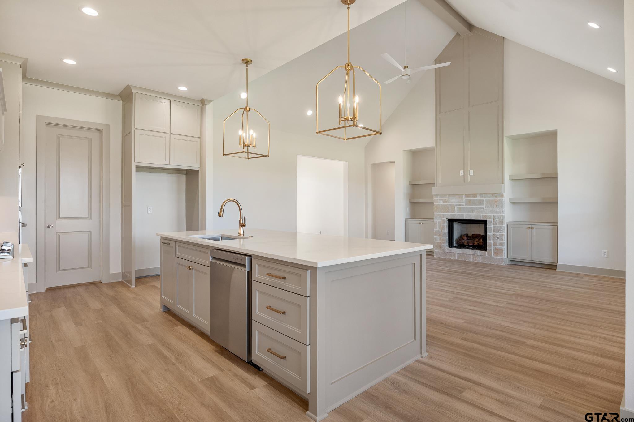 508 Artesian Meadow Drive Bullard, TX 75757 - Photo 16 of 46 a kitchen with stainless steel appliances granite countertop a sink stove and wooden floor
