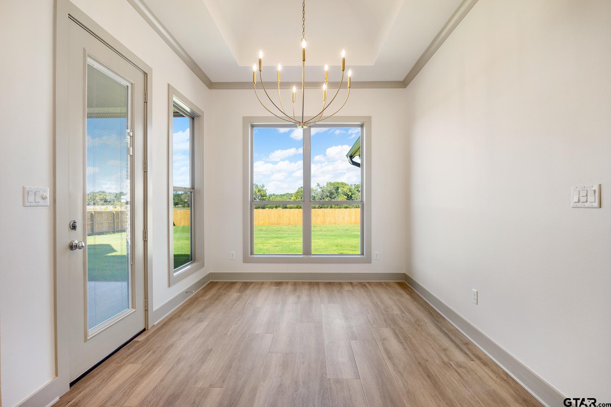 508 Artesian Meadow Drive Bullard, TX 75757 - Photo 20 of 46 wooden floor in an empty room with a window