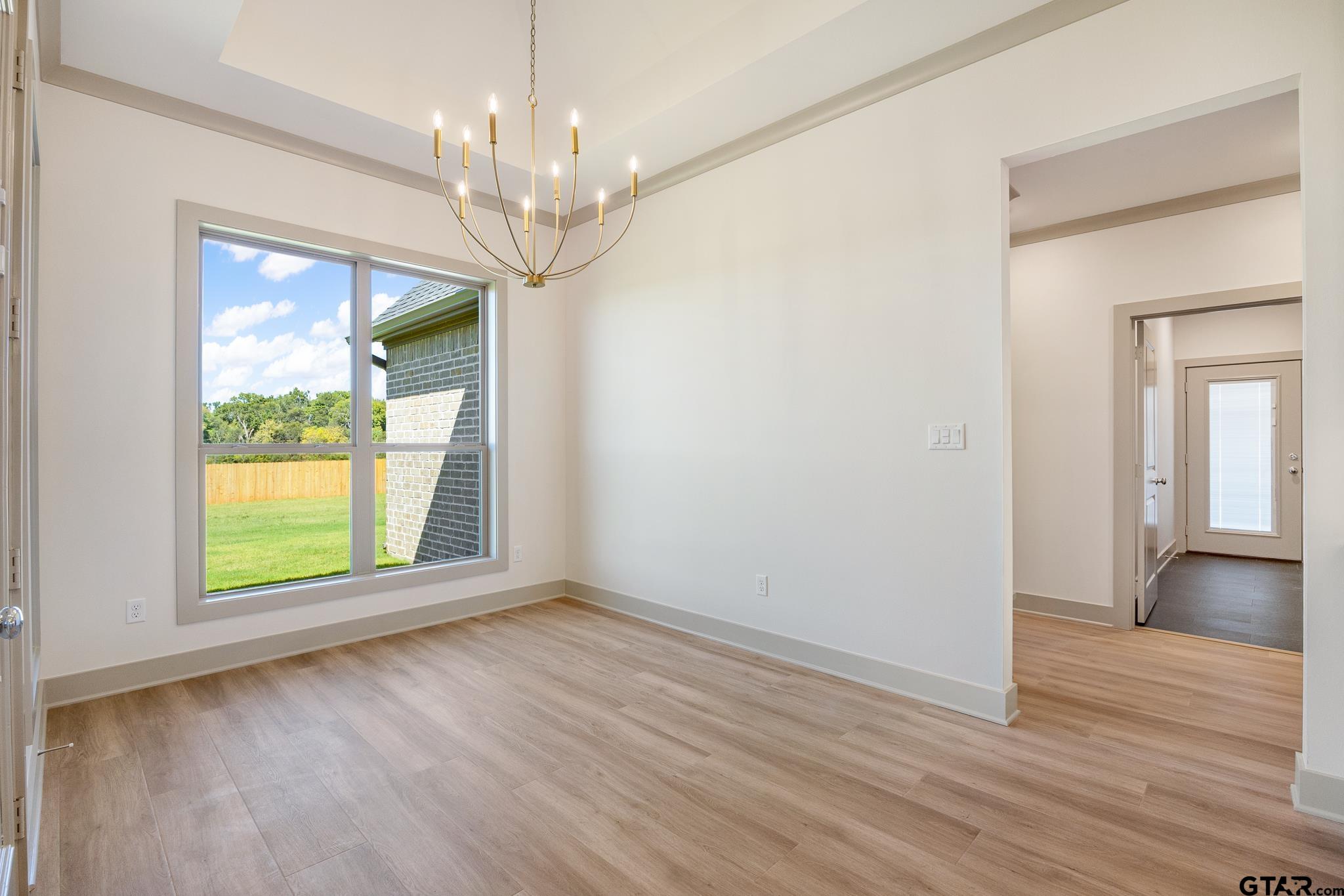 508 Artesian Meadow Drive Bullard, TX 75757 - Photo 21 of 46 a view of an empty room with wooden floor and a window