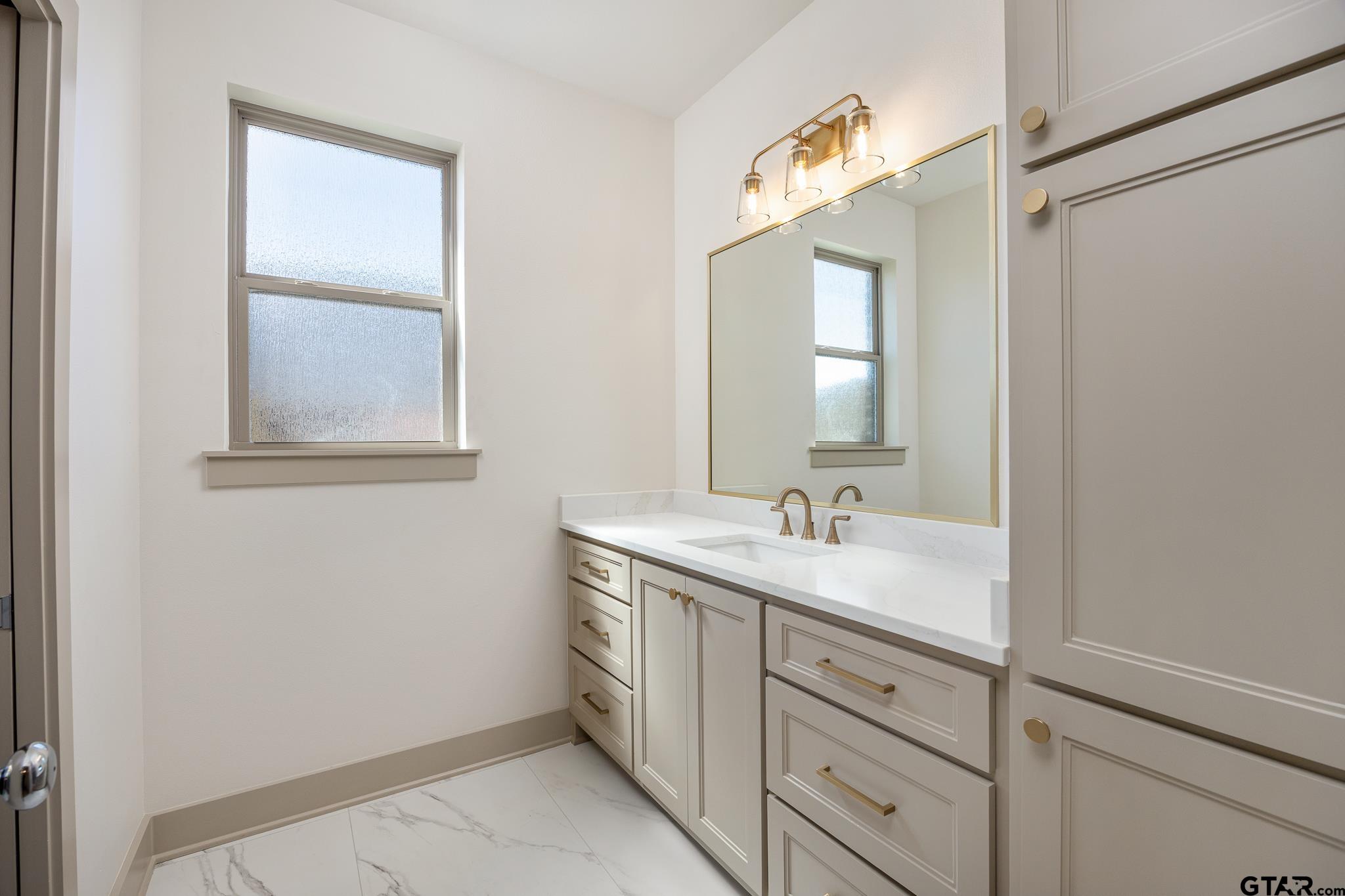 508 Artesian Meadow Drive Bullard, TX 75757 - Photo 33 of 46 a bathroom with a granite countertop sink a toilet a mirror and window