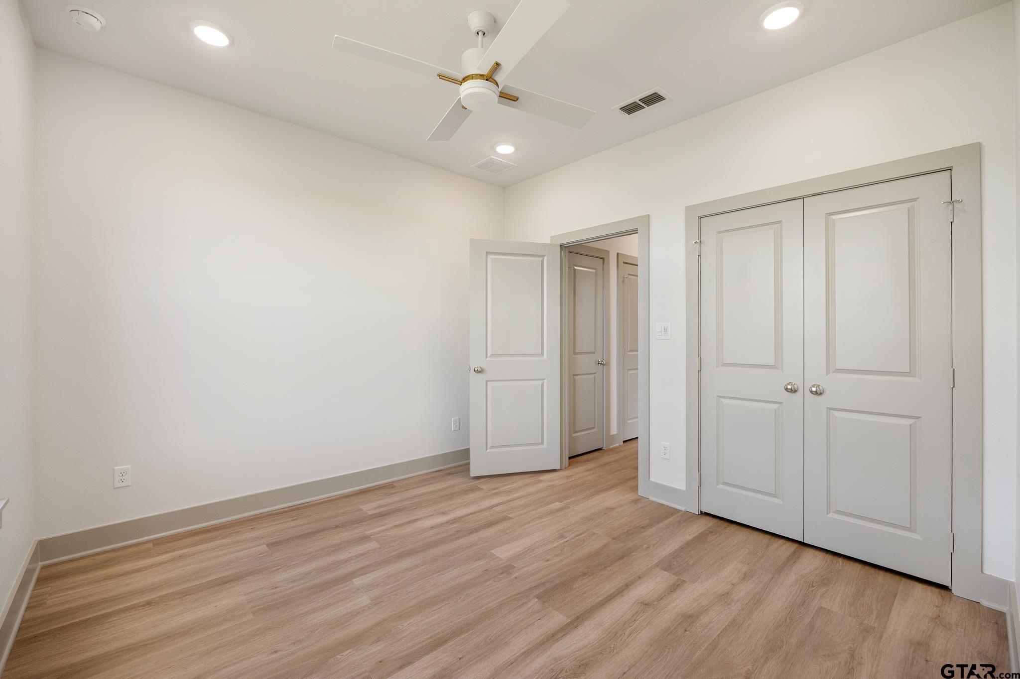 508 Artesian Meadow Drive Bullard, TX 75757 - Photo 38 of 46 wooden floor in an empty room with a ceiling fan