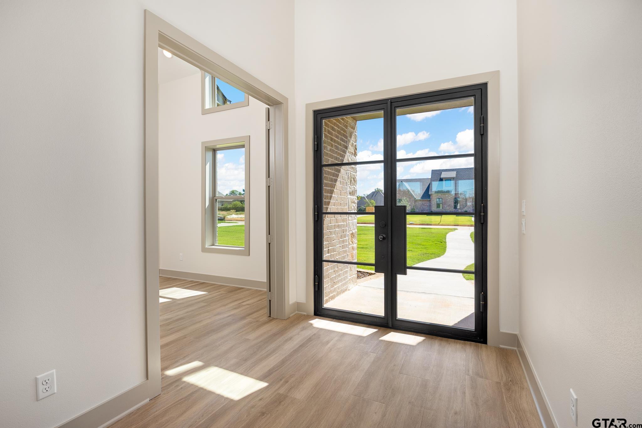 508 Artesian Meadow Drive Bullard, TX 75757 - Photo 7 of 46 wooden floor in an empty room with a window