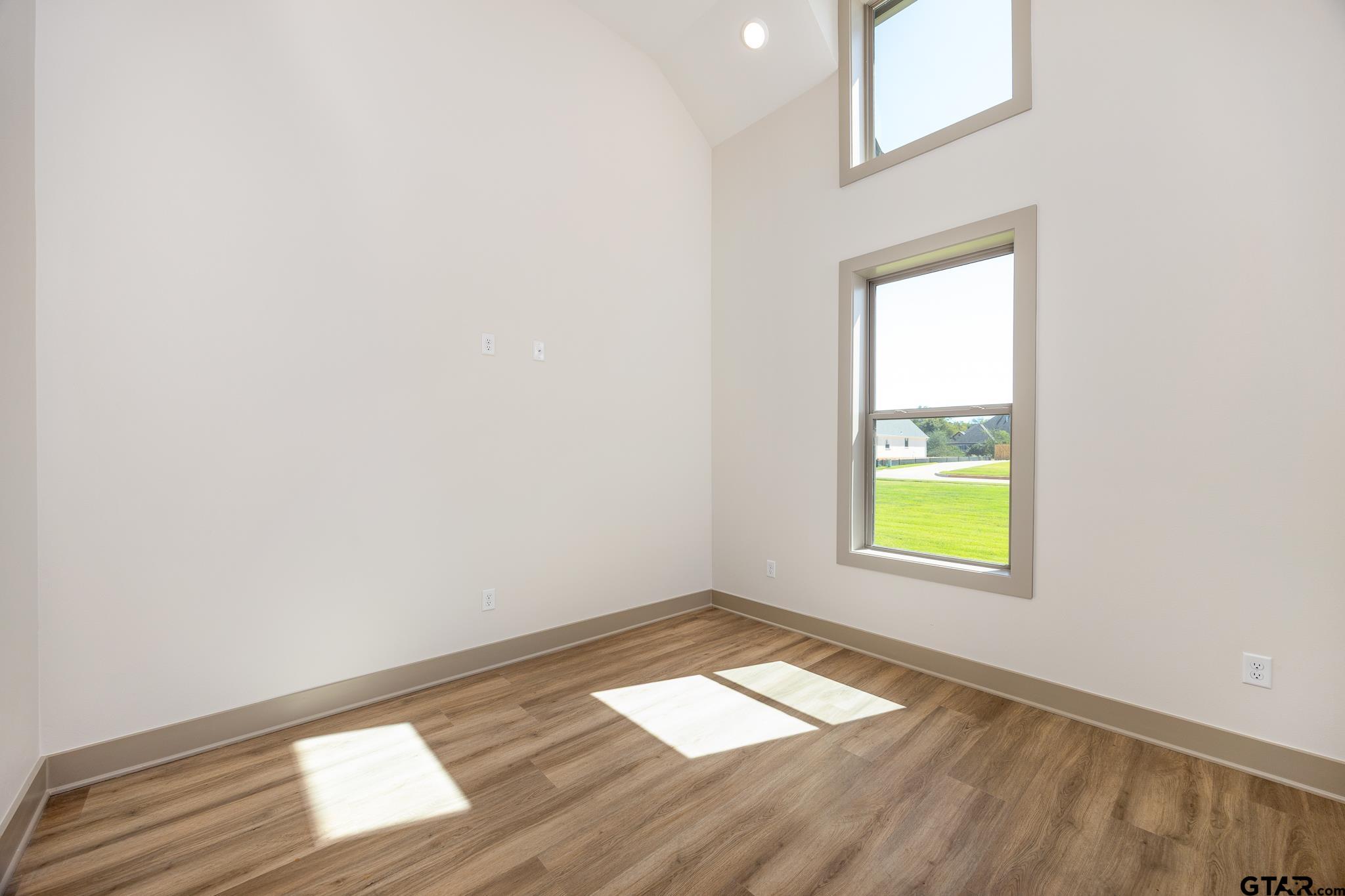 508 Artesian Meadow Drive Bullard, TX 75757 - Photo 8 of 46 an empty room with a window and wooden floor