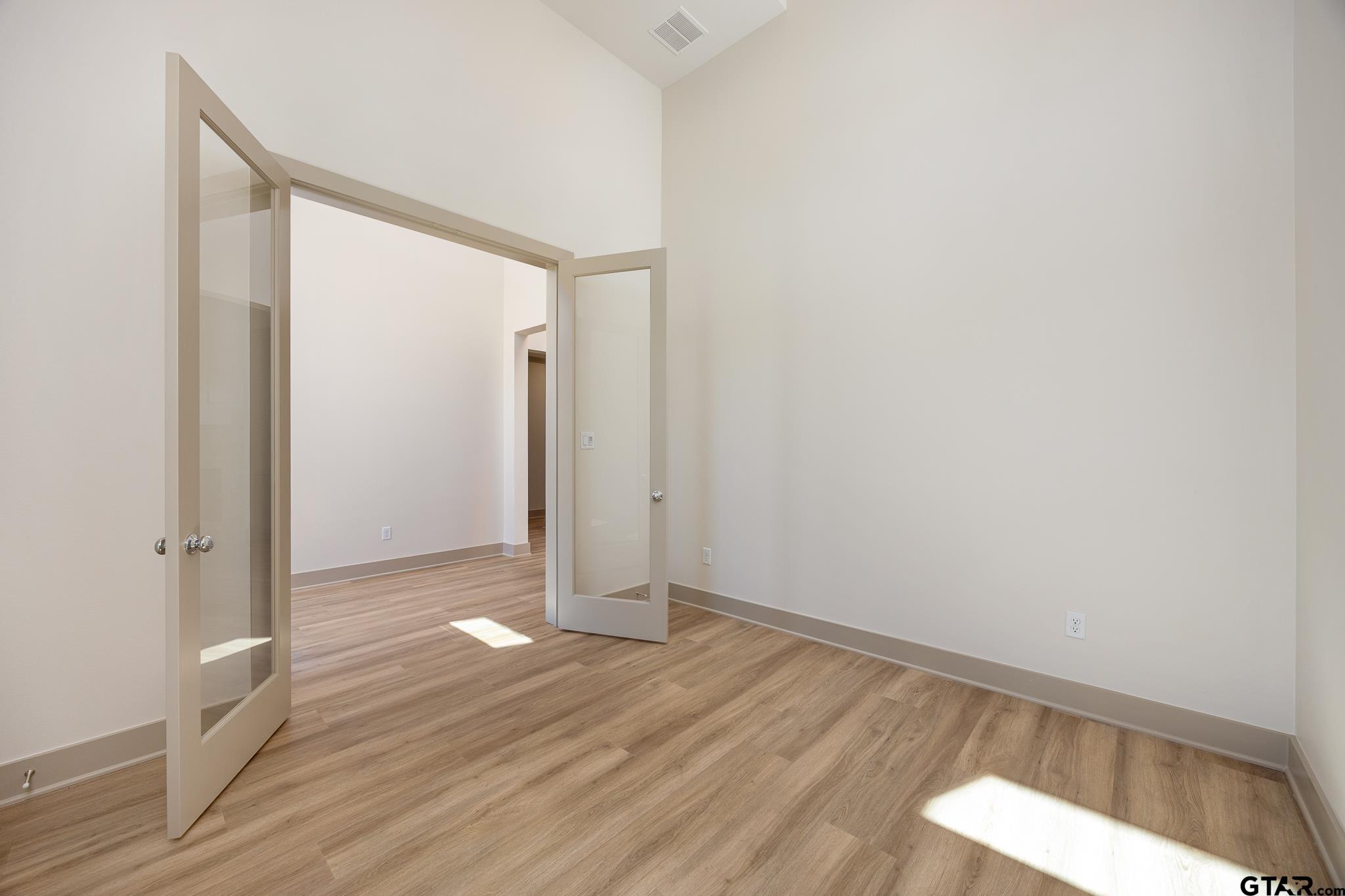 508 Artesian Meadow Drive Bullard, TX 75757 - Photo 9 of 46 a view of an empty room with wooden floor