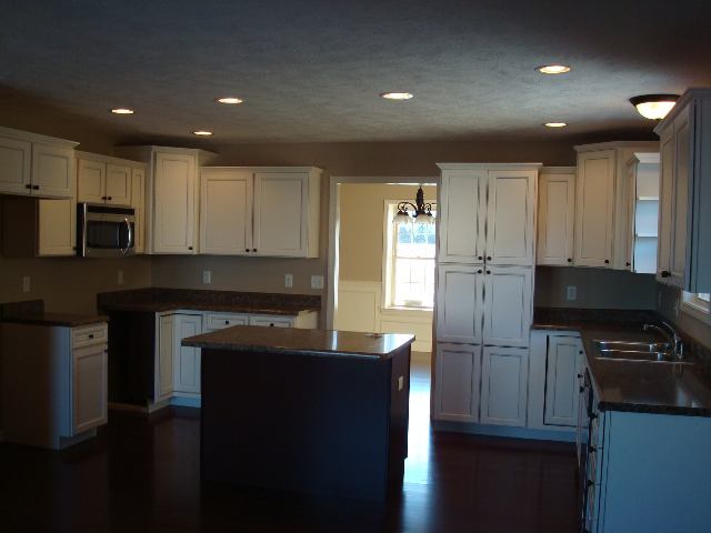 1646 Belclare Road Normal, IL 61761 - Photo 3 of 6 a kitchen with kitchen island granite countertop stainless steel appliances and wooden cabinets