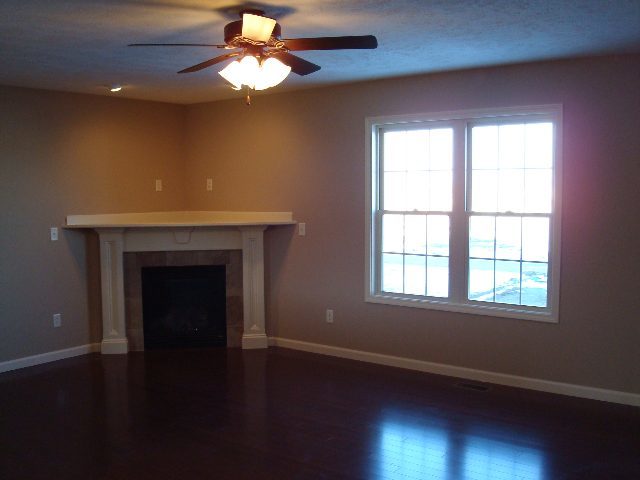 1646 Belclare Road Normal, IL 61761 - Photo 4 of 6 a view of an empty room with wooden floor and a window