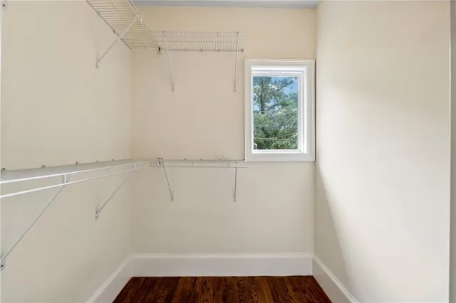 a bathroom with a granite countertop toilet sink and mirror