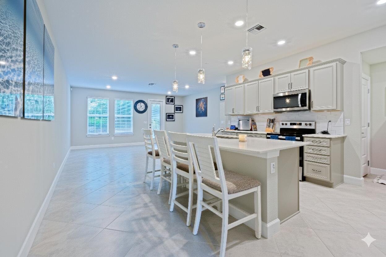 1832 Southeast Roxy Way Stuart, FL 34996 - Photo 3 of 17 a kitchen with kitchen island wooden cabinets and refrigerator