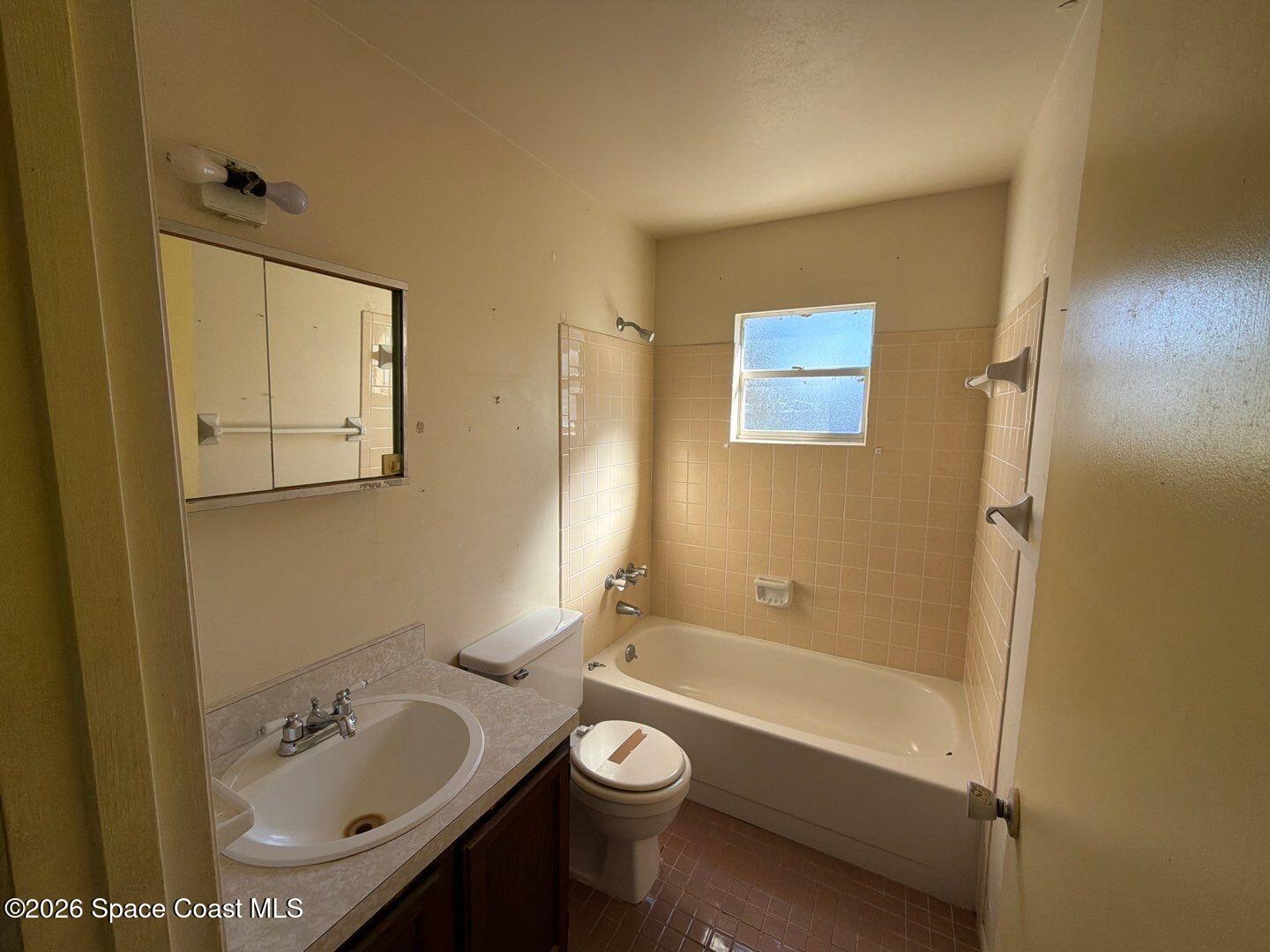 2972 Matthew Drive Rockledge, FL 32955 - Photo 12 of 24 a bathroom with a granite countertop sink a toilet and shower