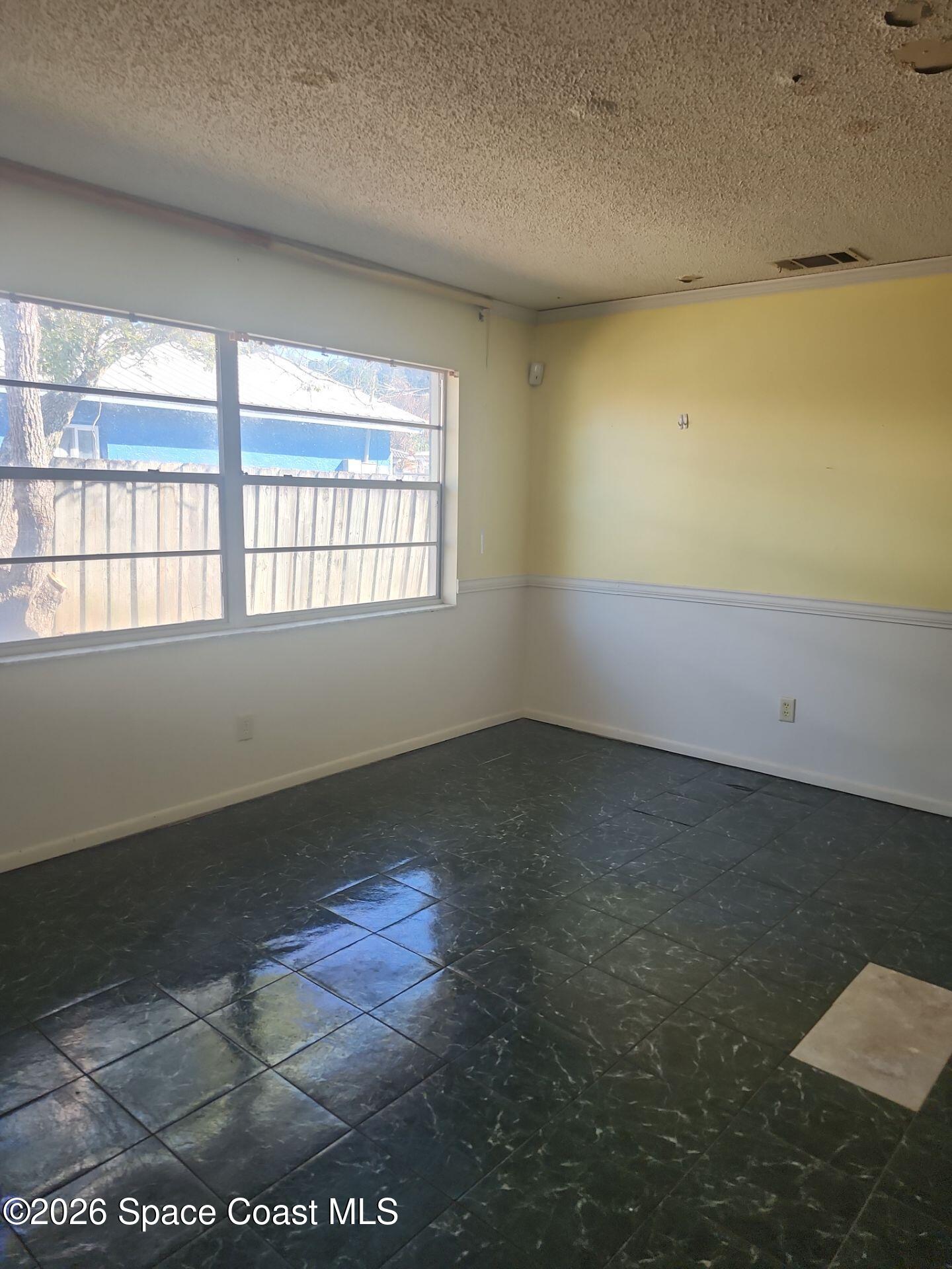 2972 Matthew Drive Rockledge, FL 32955 - Photo 13 of 24 en empty room with windows
