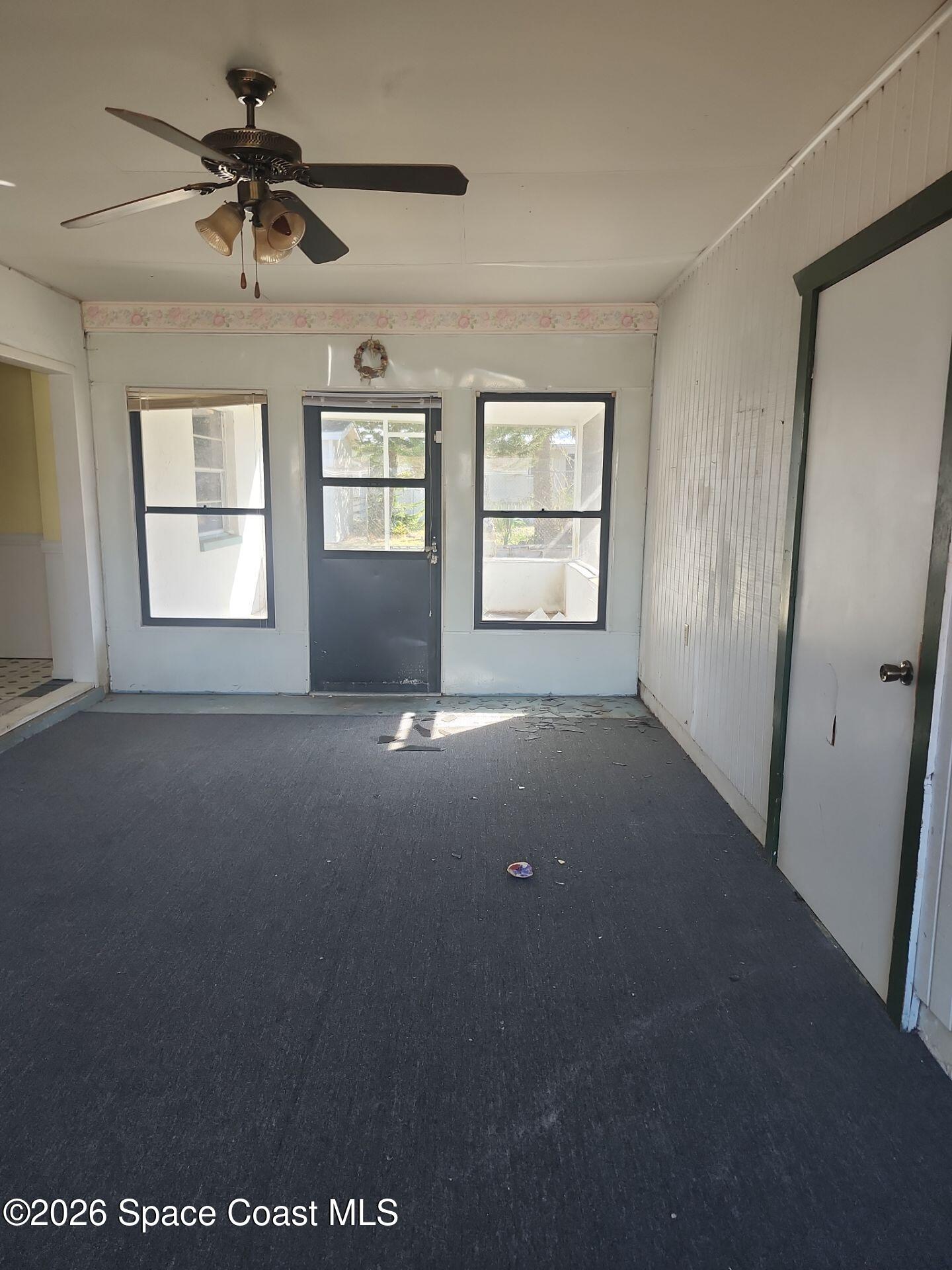 2972 Matthew Drive Rockledge, FL 32955 - Photo 14 of 24 an empty room with windows and ceiling fan