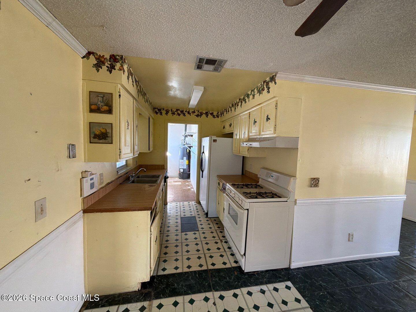 2972 Matthew Drive Rockledge, FL 32955 - Photo 3 of 24 a kitchen with a sink and a stove top oven