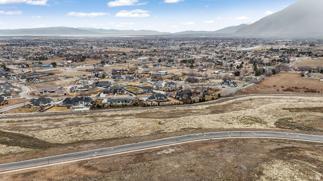 2116 South Valley View Drive, Unit 58 Mapleton, UT 84664 - Photo 12 of 13 Aerial view of property and surrounding area with a mountainous background and nearby suburban area