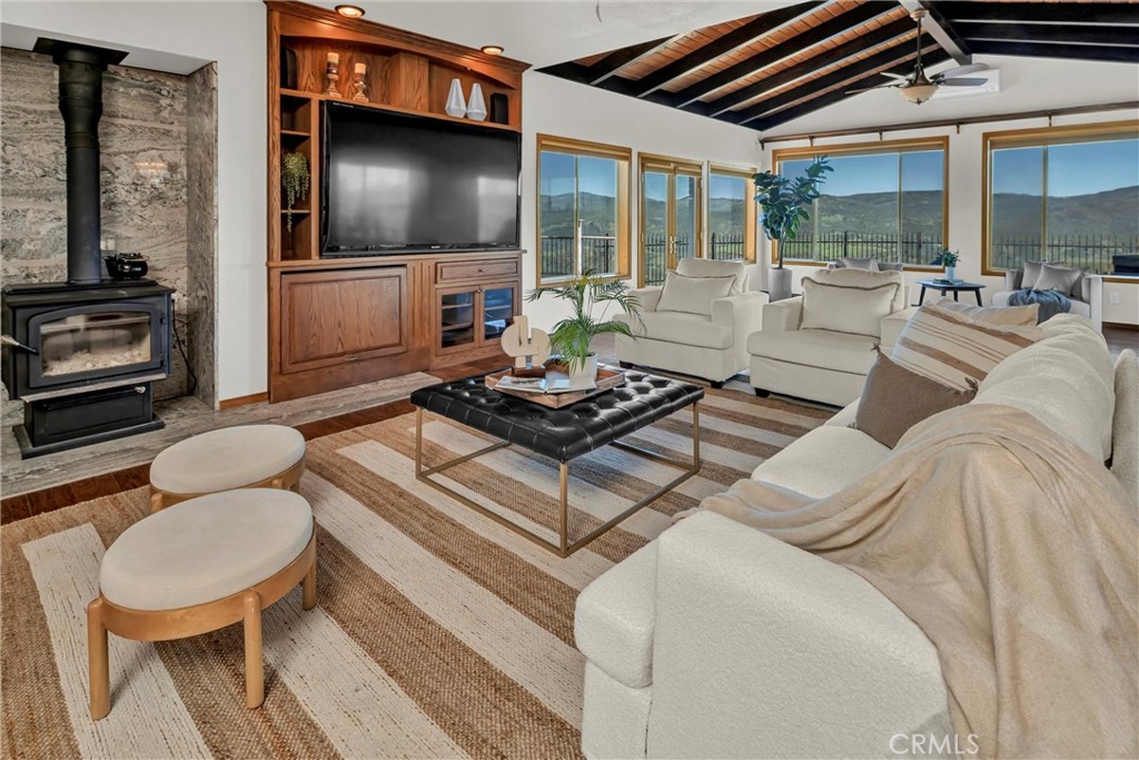 20250 Black Bass Pass Road Lower Lake, CA 95457 - Photo 16 of 66 a living room with furniture a flat screen tv and floor to ceiling window