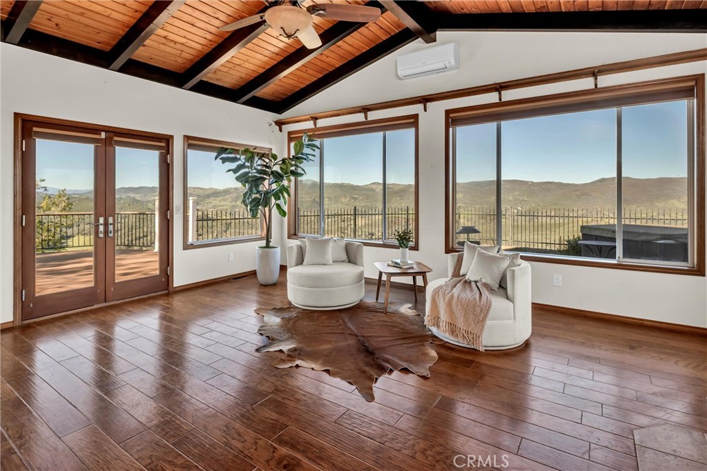 20250 Black Bass Pass Road Lower Lake, CA 95457 - Photo 17 of 66 a living room with couches and a dining table with wooden floor