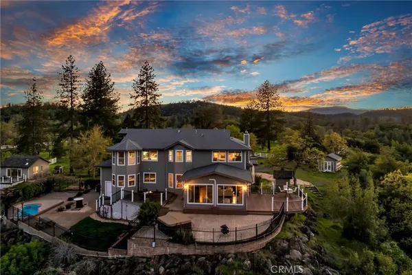 aerial view of a house with swimming pool and sitting area