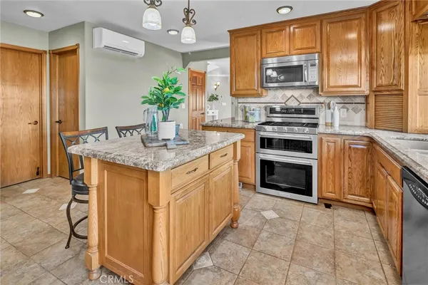 a kitchen with a refrigerator and a stove top oven