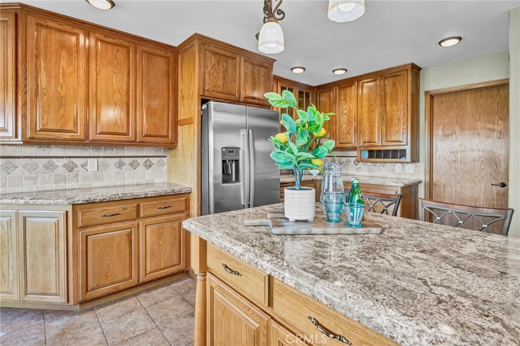 20250 Black Bass Pass Road Lower Lake, CA 95457 - Photo 23 of 66 a kitchen with stainless steel appliances granite countertop a sink a stove and a wooden cabinets